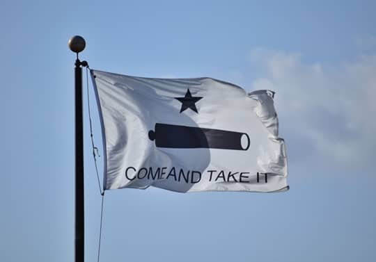 The Come and Take It flag is the best known of the Texas Revolution flags. It was designed and painted by the women of Gonzales in October 1835 to celebrate the famous cannon that sparked the Battle of Gonzales.